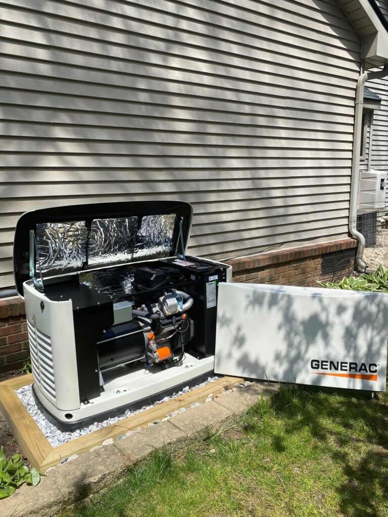 A 16 kW Generac generator with its side panel removed, showing the engine a technician examines during scheduled maintenance or warranty service.