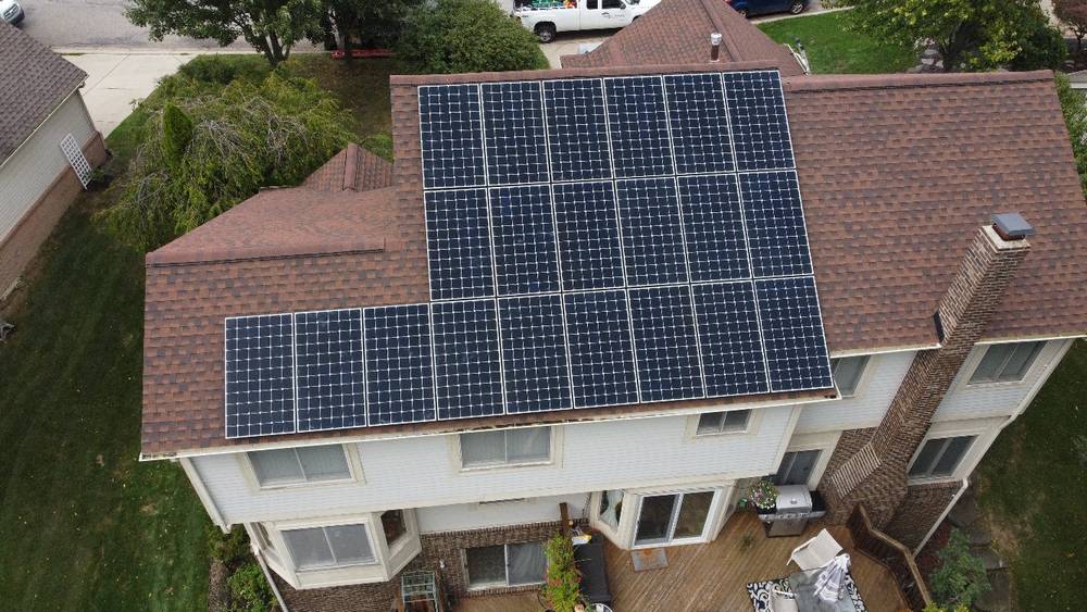 An aerial view of a house carrying an 8.4 kW solar array paired with battery storage for round-the-clock backup power.
