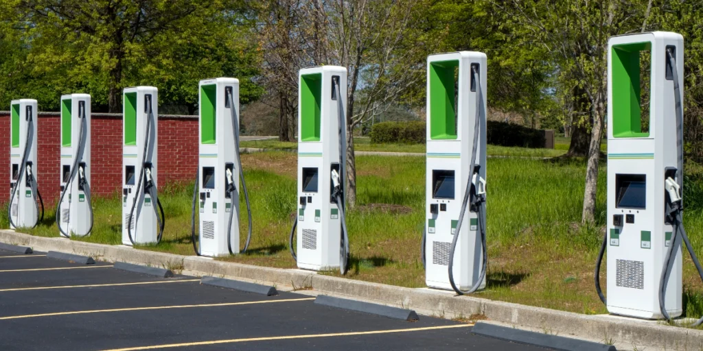 A row of commercial EV charging stations lined up across a parking lot — a multi-unit setup ENS Electric installs for West Michigan businesses.