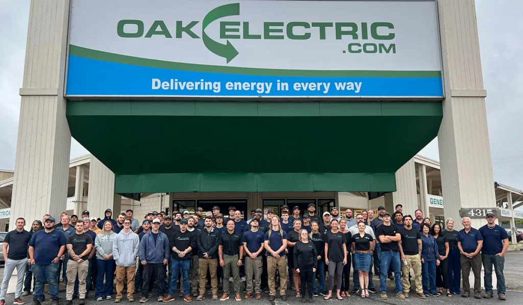 The Oak Electric team gathered outside their building under the tagline "Delivering energy in every way,". The company is a trusted partner of ENS Electric.