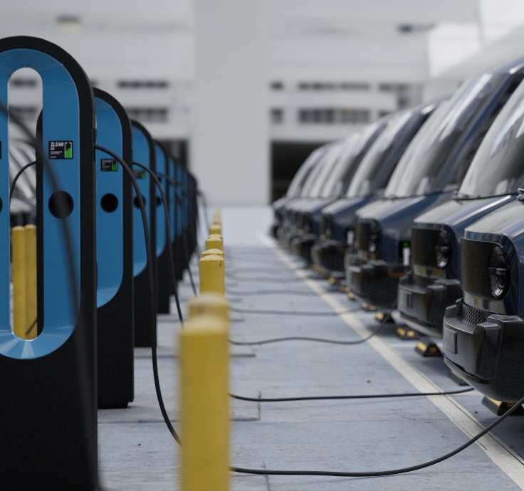 A long bank of fast chargers running down a fleet parking area, the multi-charger layout that ENS Electric installs to support several vehicles on one service feed.