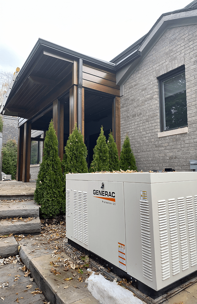A commercial Generac standby unit installed on a pad along a brick and dark-sided building, tied in to keep the Michigan business running through outages.